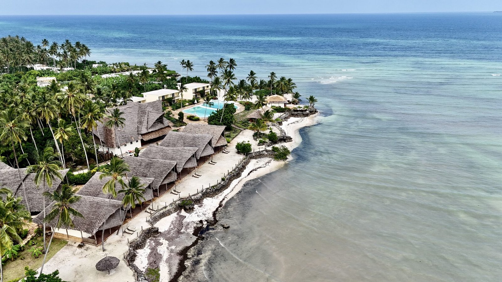 Aerial view of Maharaja Boutique Hotel, its beachfront villas and turquoise lagoon in Uroa, Zanzibar