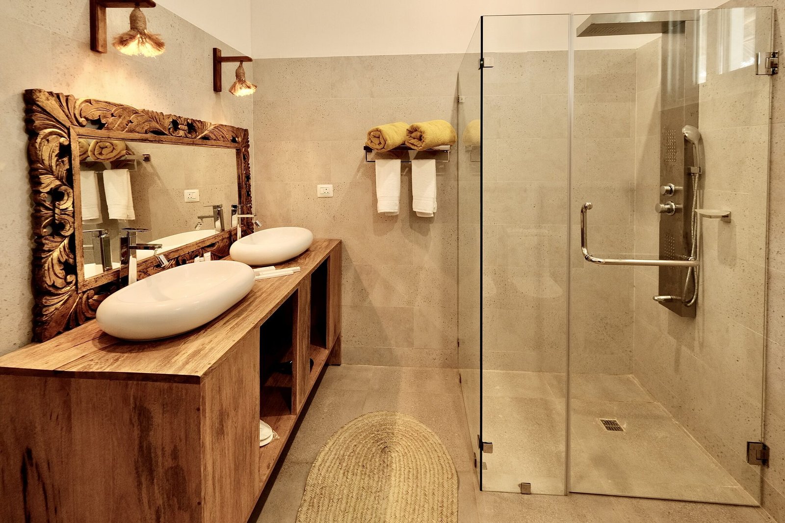 Beach Villa bathroom with walk-in glass shower and carved mirror