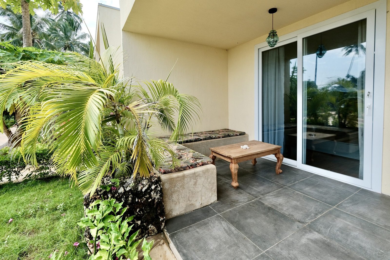 Deluxe Room private terrace opening onto tropical gardens