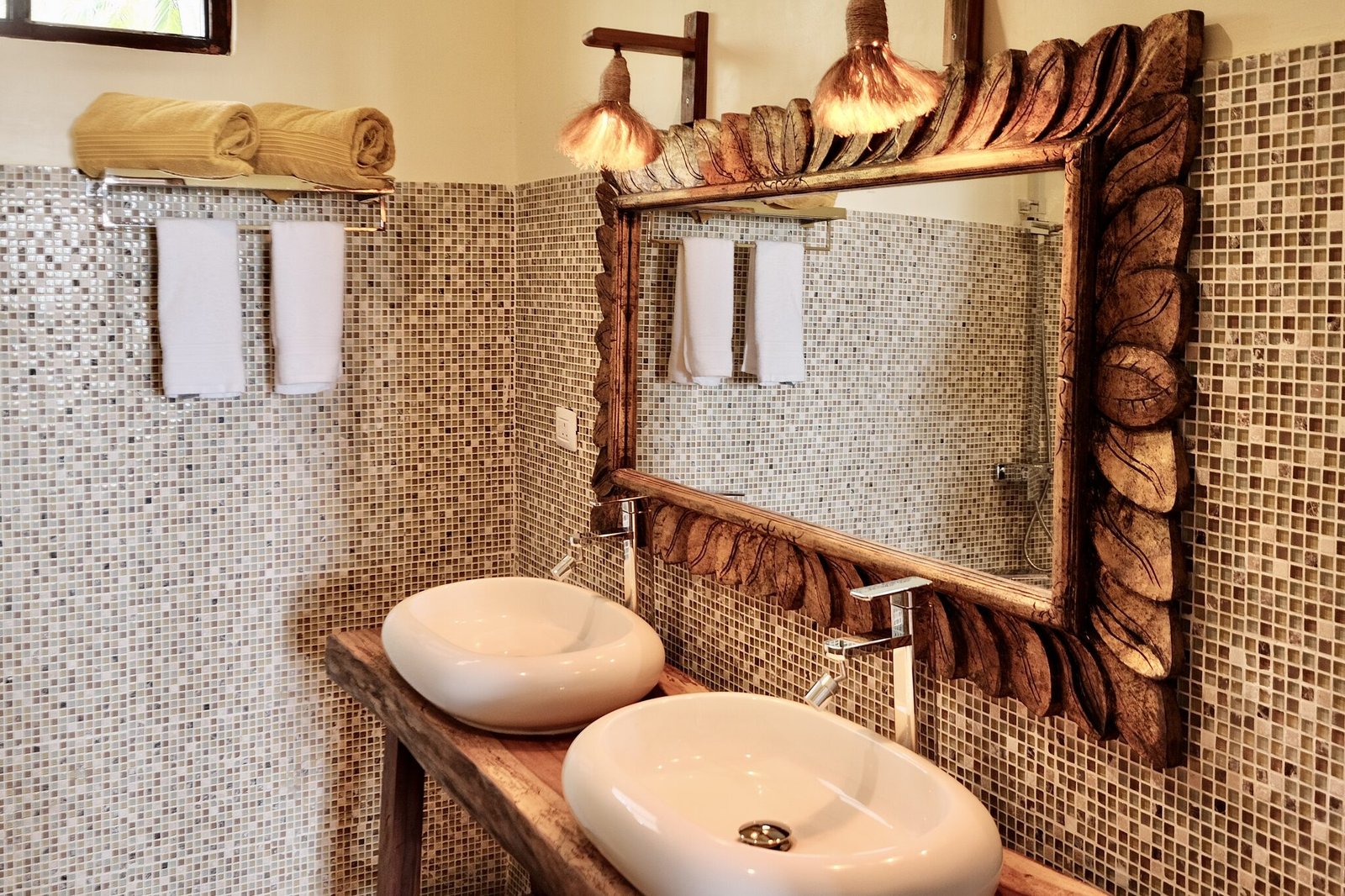 Villa Deluxe bathroom with hand-carved mirror and twin basins