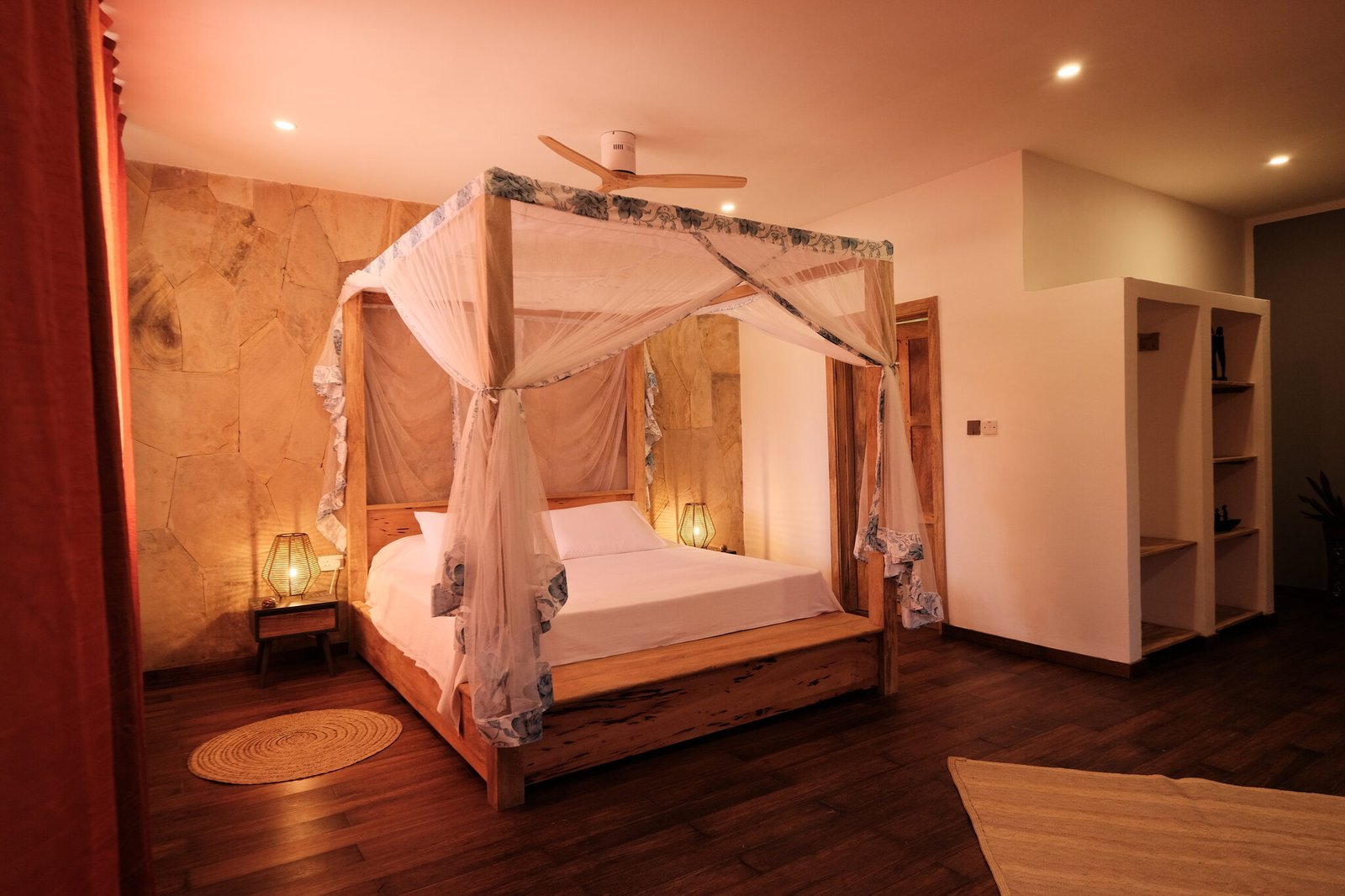 Villa Deluxe four-poster bedroom with warm lighting