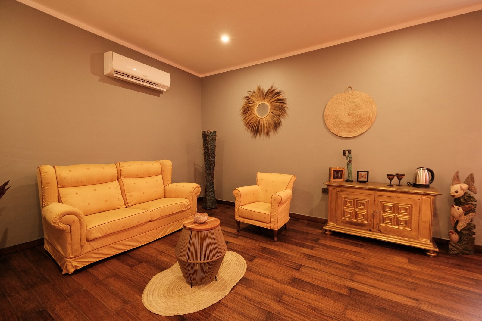 Villa Deluxe lounge with sofa and carved sideboard